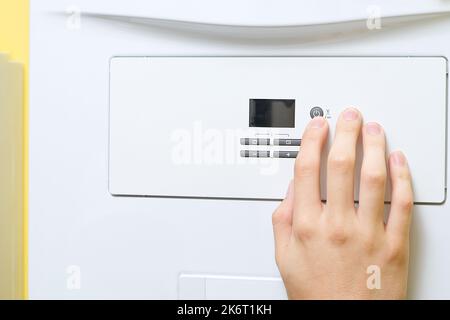 Setting up and servicing by a service department. Adjustment of gas boiler at domestic home. Stock Photo