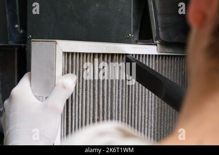 Replacing filter in the central ventilation system. hvac filter replacing home central air system Stock Photo