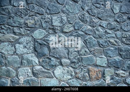 Texture of a green stone wall in the Alps Stock Photo
