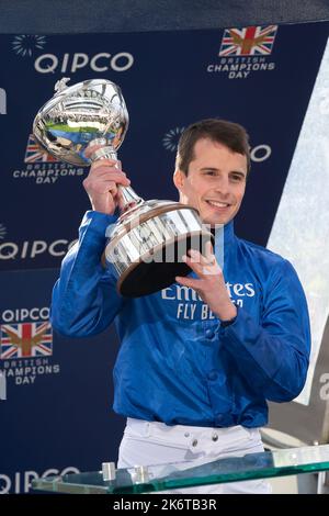 Ascot, Berkshire, UK. 15th October, 2022. William Buick realised a long-held ambition at Ascot today as he was crowned Champion Jockey for the first time. Racing legend Willie Carson presented him with the trophy. The 34-year-old has dominated the championship from the outset and begins the final day of the season on 157 winners, 67 clear of his closest challengers Hollie Doyle and Tom Marquand. Credit: Maureen McLean/Alamy Live News Stock Photo