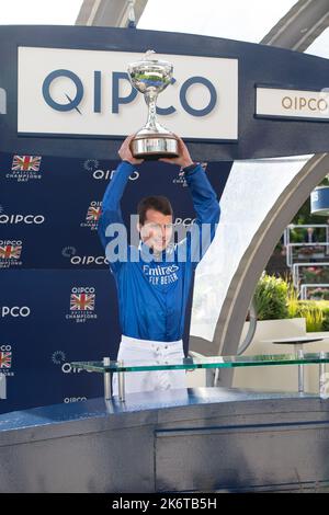 Ascot, Berkshire, UK. 15th October, 2022. William Buick realised a long-held ambition at Ascot today as he was crowned Champion Jockey for the first time. Racing legend Willie Carson presented him with the trophy. The 34-year-old has dominated the championship from the outset and begins the final day of the season on 157 winners, 67 clear of his closest challengers Hollie Doyle and Tom Marquand. Credit: Maureen McLean/Alamy Live News Stock Photo