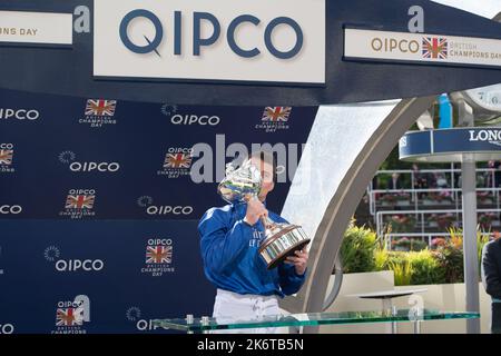 Ascot, Berkshire, UK. 15th October, 2022. William Buick realised a long-held ambition at Ascot today as he was crowned Champion Jockey for the first time. Racing legend Willie Carson presented him with the trophy. The 34-year-old has dominated the championship from the outset and begins the final day of the season on 157 winners, 67 clear of his closest challengers Hollie Doyle and Tom Marquand. Credit: Maureen McLean/Alamy Live News Stock Photo