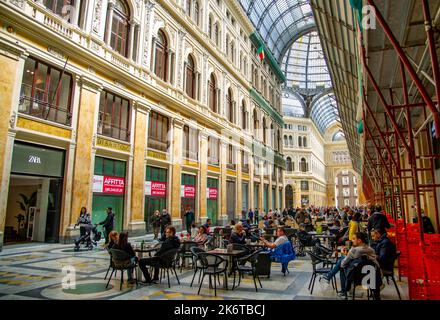 April 09 2022- Galleria Umberto. Interior of ancient gallery . Shopping and tourism in Europe.Tourists drink coffee and walking Stock Photo