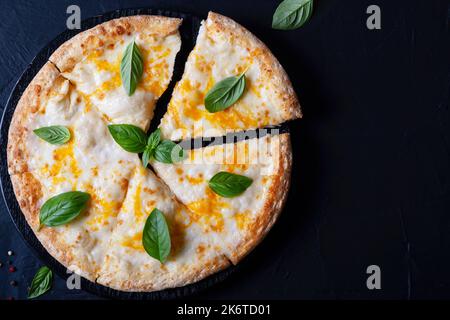Italian pizza Margherita with cheese and basil on black concrete table top view Stock Photo