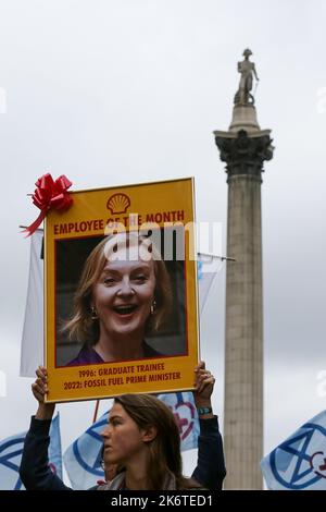 London, UK. 14th Oct, 2022. A protester holds a picture of British Prime minister Liz Truss as hundreds of Extinction Rebellion protesters demonstrate in Westminster against climate change crisis and rising energy bills. Credit: SOPA Images Limited/Alamy Live News Stock Photo