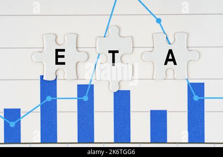 Business concept. On business reports - diagrams are puzzles with the inscription - ETA Stock Photo