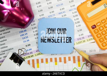 Top view of magnifying glass,plant.glass globe,clock,mobile phone,pen and notebook written with Join Our Newsletter on wooden background. Stock Photo