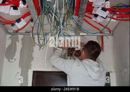 Electrician technician at work on electric installation Stock Photo