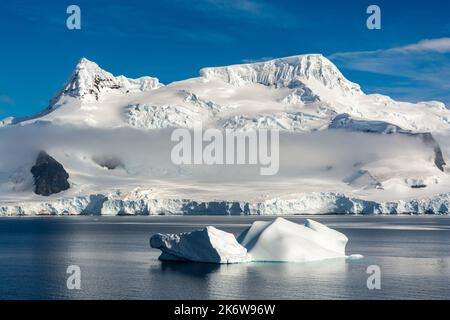 iceberg in front of wall range on wiencke island looking from gerlache strait. antarctic peninsula. antarctica Stock Photo