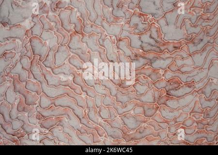 Limestone floor in Pamukkale calcium travertine in Turkey, asymmetric pattern close-up. White cotton castle texture. Red Calcium stone textured. Limes Stock Photo