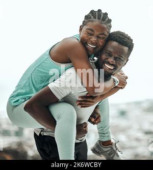 You can count on me for support. a young man giving his friend a piggyback ride. Stock Photo