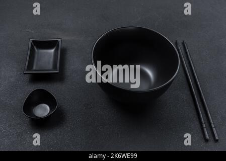 Empty black ceramic plate on a background of black stone. Top view, flat plan Stock Photo