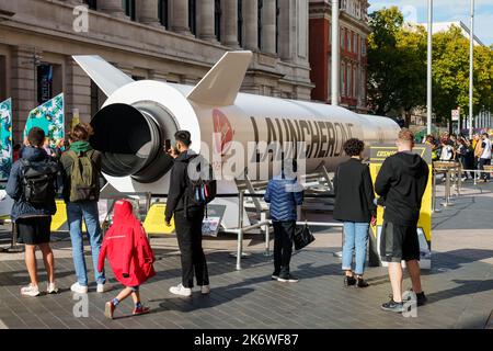 EDITORIAL USE ONLY Members of the public look at a 72ft life size replica of Virgin Orbit's LauncherOne, which is on display at the Science Museum in London. The rocket will be launched later this year in UK's first space launch from Spaceport Cornwall, with support from the UK Space Agency. Picture date: Saturday October 15, 2022. Stock Photo