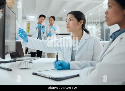 Testing is essential when it comes to our field. two scientists helping one another in the lab. Stock Photo