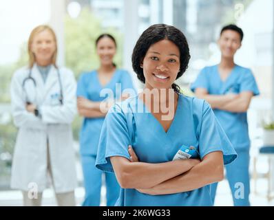 Ready and bright-eyed. a group of medical practitioners standing together in a hospital. Stock Photo