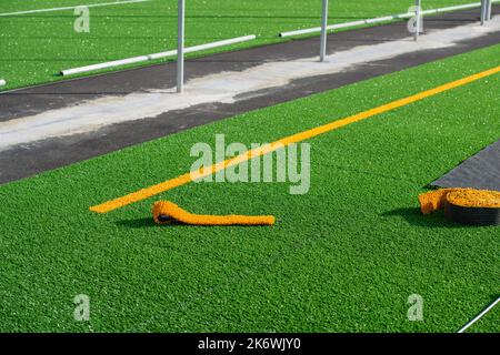 Laying of synthetic grass in a sports center Stock Photo