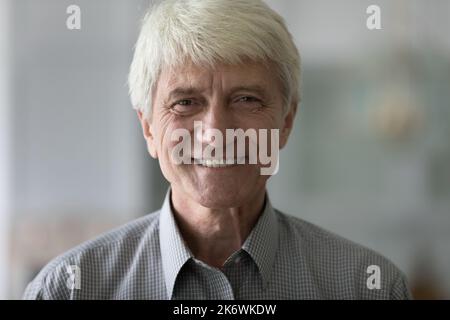 Closeup shot handsome elderly man look at camera Stock Photo