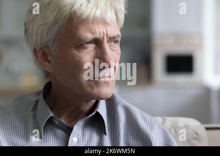 Close up cropped shot portrait of melancholic mature man Stock Photo