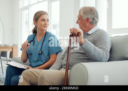 It looks like youve been following the list. a young doctor running through a checklist with her patient during a checkup at home. Stock Photo