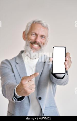 Old business man pointing at phone with white mock up screen, vertical. Stock Photo