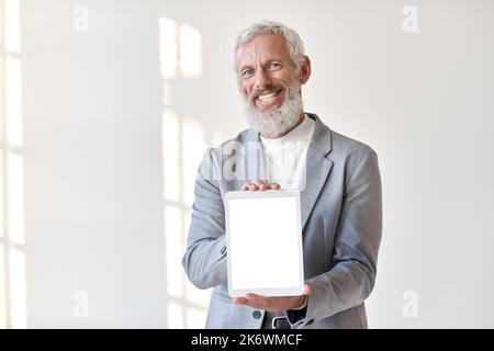 Smiling older business man showing tablet mockup screen isolated on white. Stock Photo