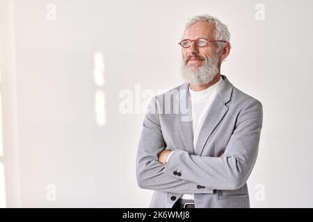 Smiling senior older business man looking away isolated on white, portrait. Stock Photo
