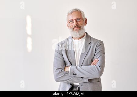Confident senior older business man isolated on white wall, portrait. Stock Photo