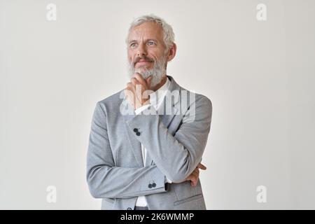 Thoughtful senior older business man looking away thinking isolated on white. Stock Photo
