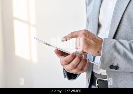 Male hands businessman using digital tablet technology corporate fintech. Stock Photo