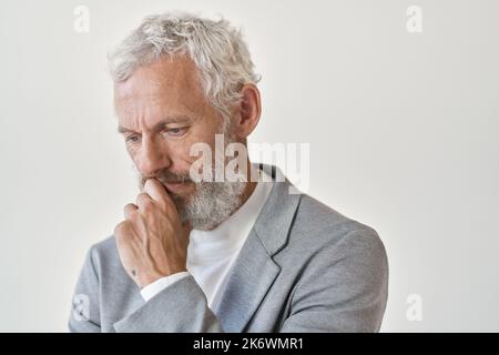 Thoughtful sad senior old business man thinking isolated on white wall. Stock Photo