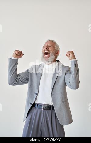 Excited older businessman investor raising fists celebrating isolated on white. Stock Photo