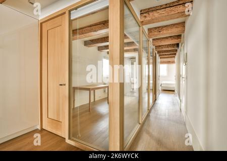 Interior of narrow corridor with telephone in daylight Stock Photo