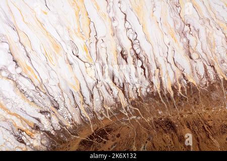 Creative abstract hand painted background, wallpaper, texture, closeup. Fragment of liquid acrylic painting in brown, beige, white, orange, yellow on Stock Photo
