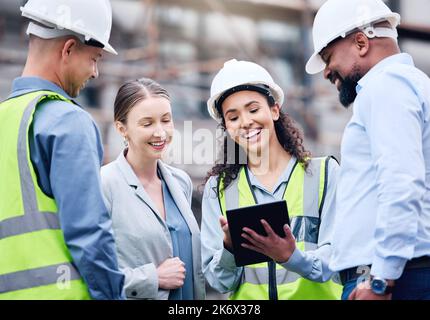This is what its going to look like. a group of architects using a digital tablet at a building site. Stock Photo