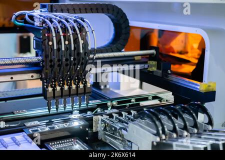 Automatic SMD pick and place machine assembling computer circuit board Stock Photo