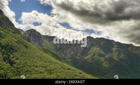 Aerial view of hillside in front of steep mountains, in Abruzzo, Italy - circular drone shot Stock Photo