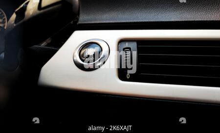 Car engine start button black and white close-up Stock Photo