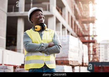 Watching my ideas take shape. a young male construction worker day dreaming while on site. Stock Photo