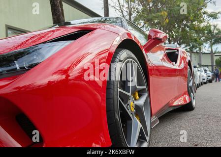 Atibaia - Brazil, October 7, 2022: Low front side view of red Ferrari F8 Tributo parked. Mid-engined rear drive sports car. Ferrari is an Italian luxu Stock Photo