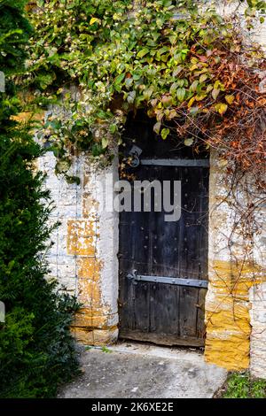Old door in the walled garden at Lytes Cary Manor House near Charlton Mackrell and Somerton, Somerset, England, United Kingdom. Stock Photo