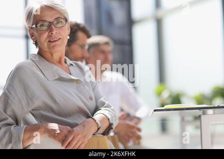 60 year old business woman in a work environment Stock Photo