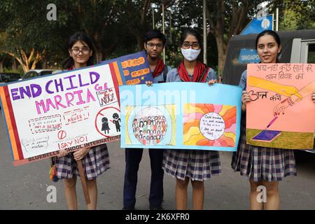 Students from different schools hold placards during ‘Child marriage-free India campaign’ held by an NGO at Sanjay Camp slum area in New Delhi in India on Sunday, October 16, 2022. More than 500 children and community women gathered to witness the campaign. India observes child girl marriages before the legal age due to lack of literacy amongst the people living in villages and slums. Photo by Anshuman Akash/ABACAPRESS.COM Credit: Abaca Press/Alamy Live News Stock Photo