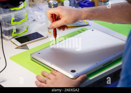 Professional computer and tablet repair shop or service. Laptop back cover. Electronics concept. Laptop under repair Stock Photo