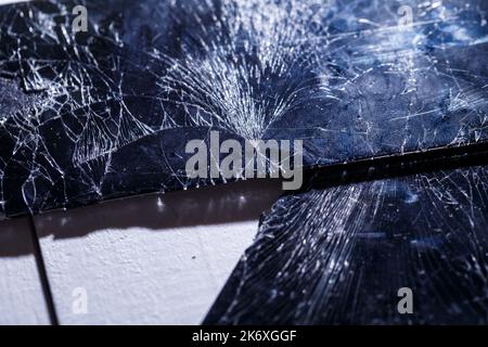 Mobile tablet device with a broken badly cracked shattered glass on the touch screen. Smart hardware part replacement, fixing concept Stock Photo