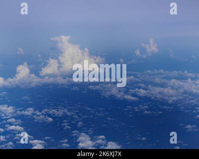 Aerial view of tranquil cloudscape in the blue sky with landscape ground below, nature wallpaper Stock Photo
