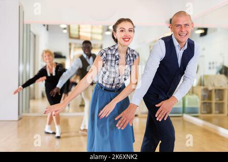 Man and woman performing jazz dance in dancing room Stock Photo