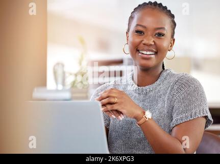 Working my way to the top. a young businesswoman working on her laptop. Stock Photo