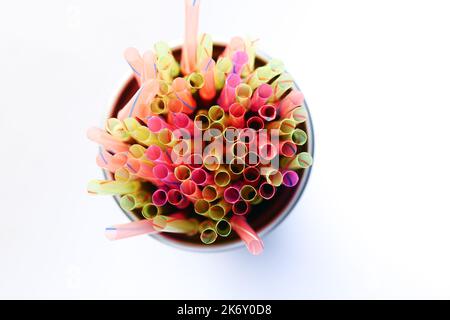 Colored striped bright plastic straws in a jar  Stock Photo