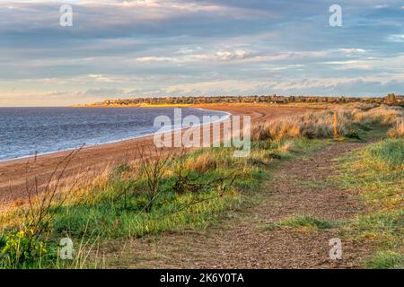 View along Heacham South Beach towards Hunstanton in north west Norfolk on a fine autumn evening. Stock Photo