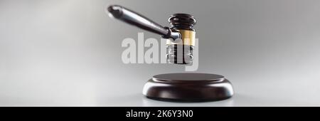 Brown wooden judge's gavel on a gray background Stock Photo